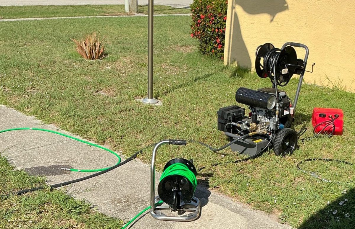 Technician performing main line hydro jetting to clean sewer line in Southwest Florida